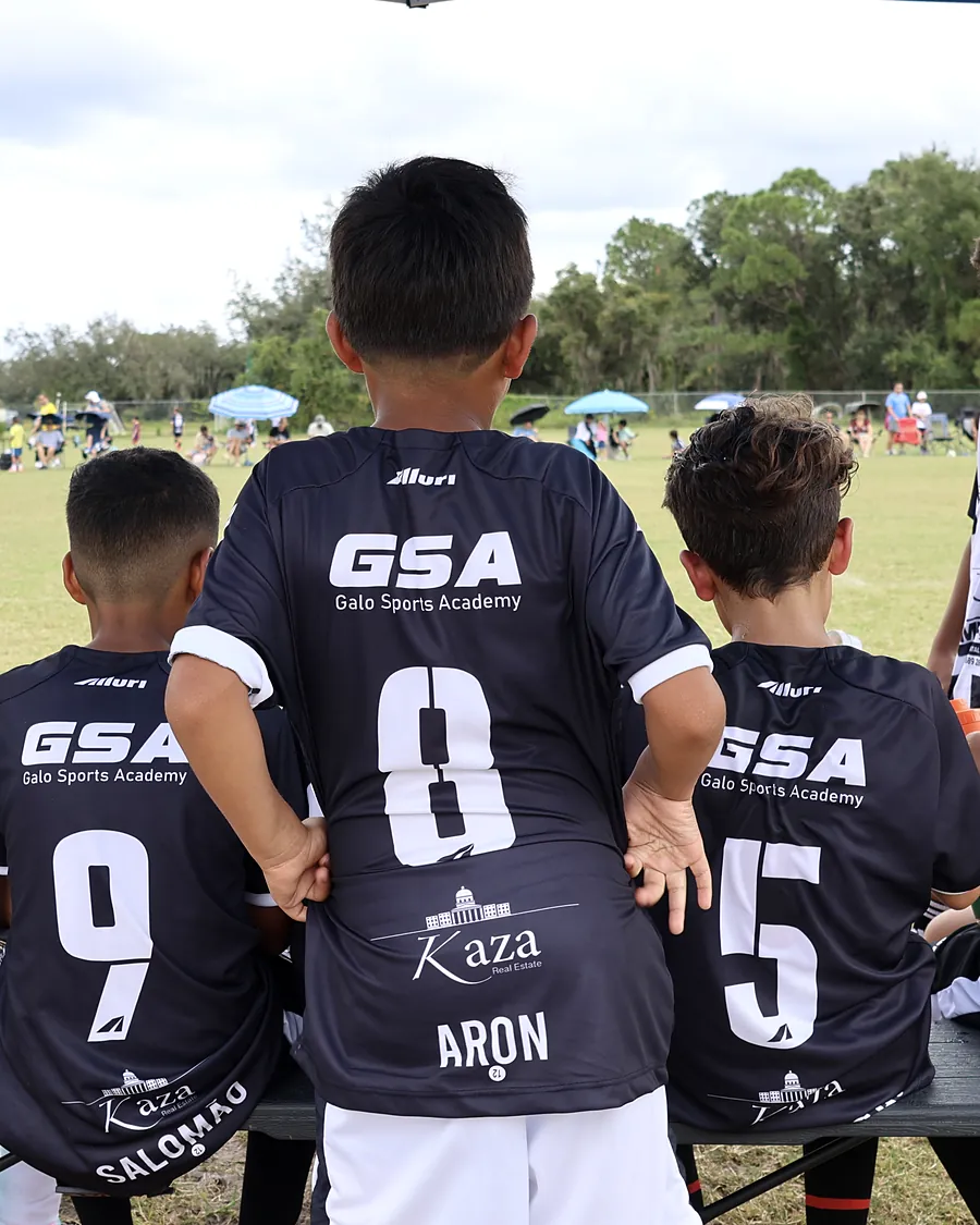 Players on the bench in black jerseys