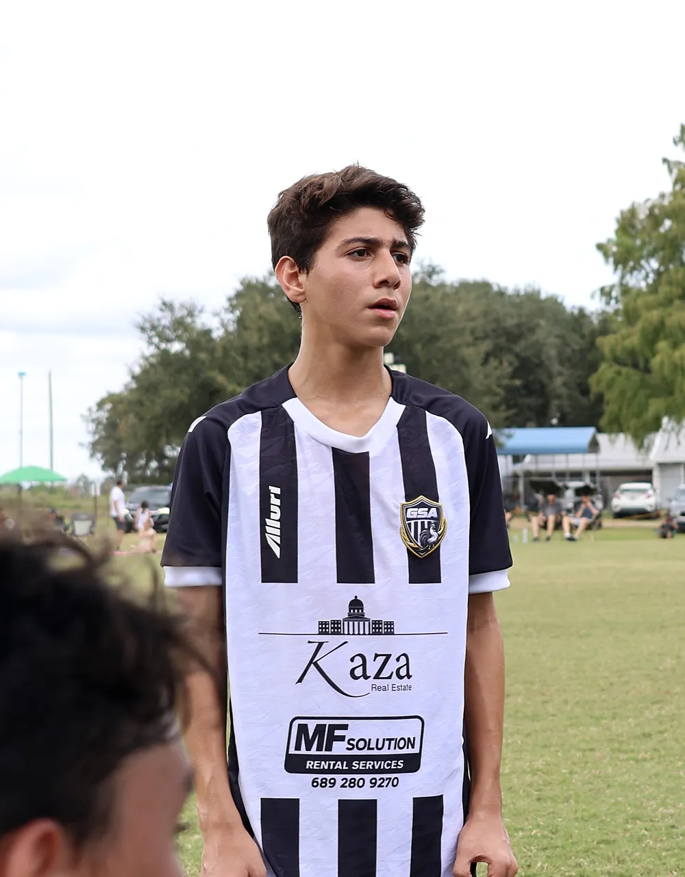 Teenage Galo player in the striped jersey